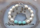 CFB943 Hand-knotted 9mm - 10mm rice white freshwater pearl & blue howlite bracelet